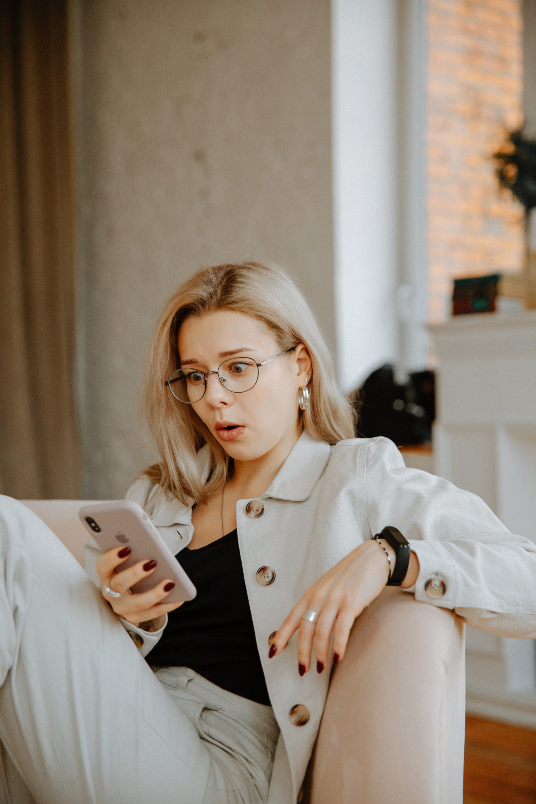 woman in beige coat holding smartphone 3958892 scaled